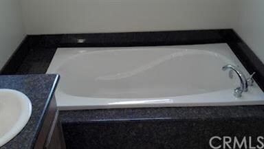Master bath has dual sink vanity and soaking tub s