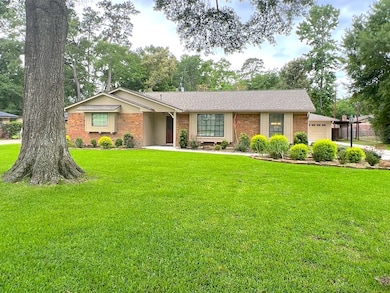 Single story home with brick siding, a front lawn,