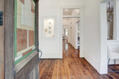 An antique front door with stained glass opens int