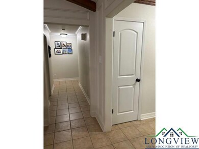 Hall with light tile patterned floors and ornamental molding
