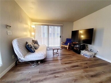 Sitting room with vaulted ceiling, baseboards, and
