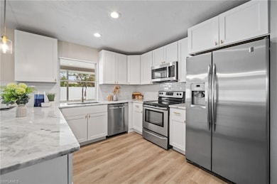 Kitchen with sink, decorative light fixtures, ligh
