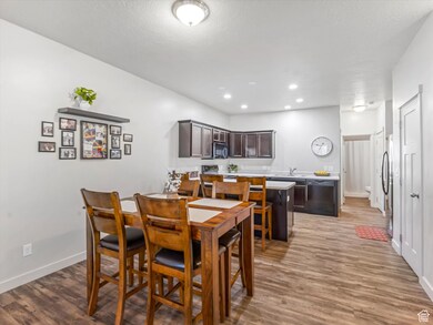 Dining space with wood finished floors and recessed lighting
