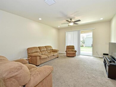 Living room with glass sliders to outdoor patio ma