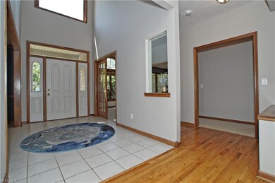 Two story entryway has ceramic floors and leads to