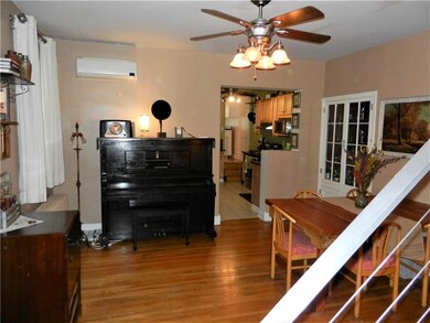 Spacious dining room with hardwood floors.