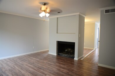 Another view of the den with the fireplace, flows 