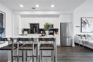 Kitchen featuring dark wood-type flooring, tastefu