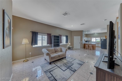 Living area with baseboards and light tile pattern