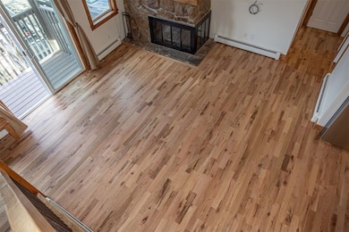 Unfurnished living room with a baseboard radiator,