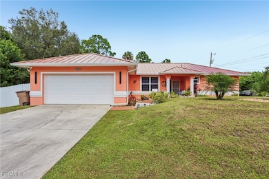 Single story home with a metal roof, concrete driveway, a standing seam roof, a garage, and stucco siding