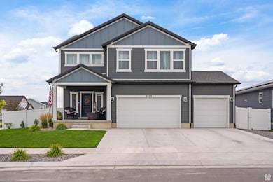 View of front of property featuring covered porch, board and batten siding, driveway, and an attached garage
