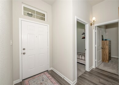 Foyer entrance featuring dark wood-style floors an
