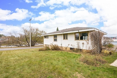 View of property exterior featuring a lawn