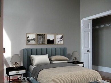 Master suite with wood flooring
