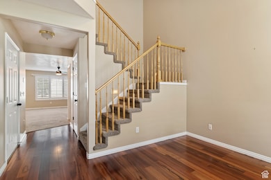 Stairway with baseboards and hardwood / wood-style floors