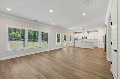 Unfurnished living room featuring crown molding, light wood-style flooring, and recessed lighting