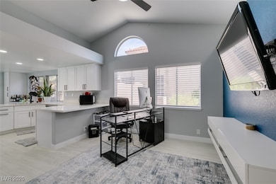Office space with a ceiling fan, light wood-type f