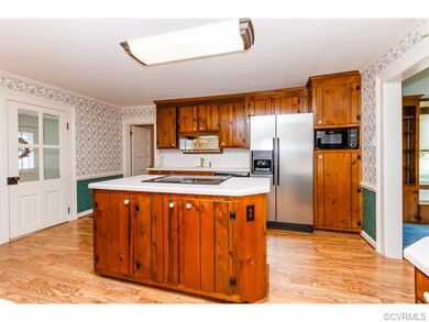 Island with cabinetry and tons of counter space. E