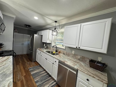 Kitchen featuring stainless steel appliances, whit