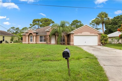 Single story home with a front lawn and a garage