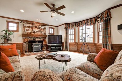 Huge Family Room with Wood Floors, Wainscoting, Re