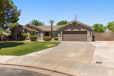 Single story home featuring concrete driveway, stucco siding, a tile roof, and a garage