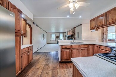 Kitchen with beautiful wood floors, oak cabinets and Corian tops.