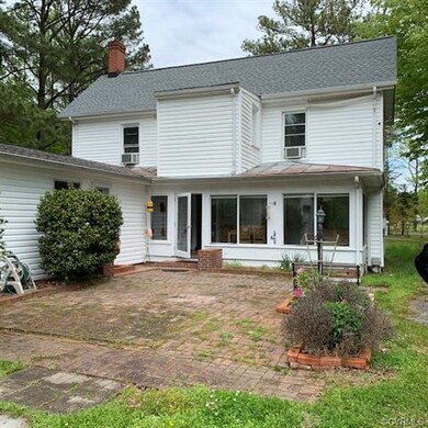 Rear of home.  Sunroom overlooking large brick pat