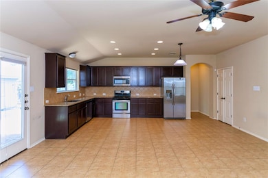 Kitchen with stainless steel appliances, arched w