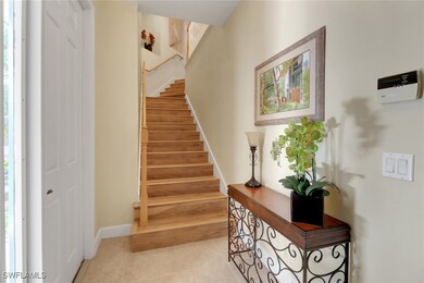 Stairs with tile patterned flooring and baseboards