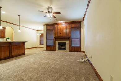 Carpeted living room featuring crown molding, ceil