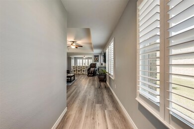 Hall featuring light Luxury Vinyl style flooring