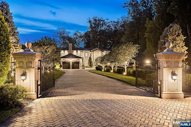 A Gated Paver Driveway Leads to a Stunning Front Courtyard