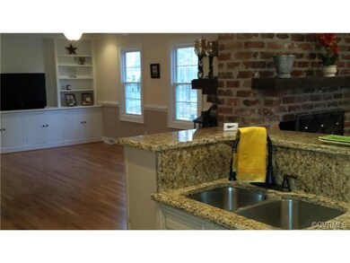 Looking from kitchen into Family Room one can see the back to back gas fireplaces in each room.  The center island holds a deep doulbe recessed sink, dishwasher and makes a great place to gather.