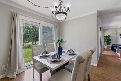 Dining room with ornamental molding, wood finishe