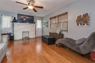The large living room is bright with lots of natur