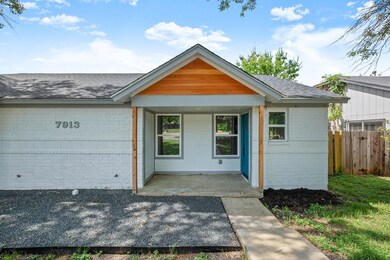 Ranch-style home featuring brick siding, covered 