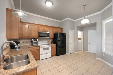 Kitchen with stainless steel microwave, white rang