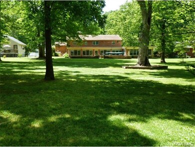 Situated on nearly an acre of mature trees and gre