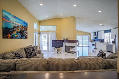 Living room featuring a textured ceiling, lofted c