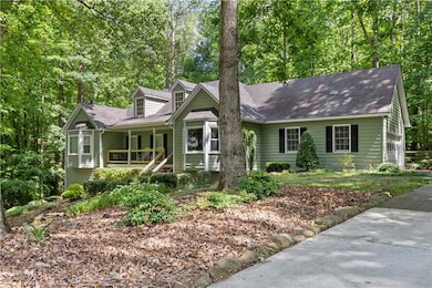 View of front of home featuring covered porch and a shingled roof