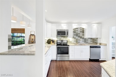Kitchen with sink, stainless steel appliances, dar