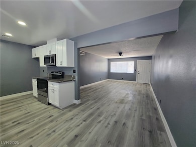 Kitchen featuring visible vents, baseboards, open