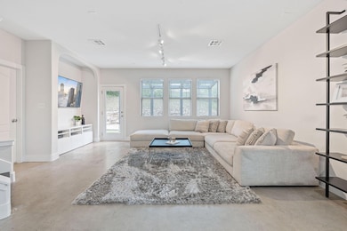 Living area with rail lighting, visible vents, ba