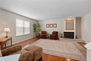 Hardwood Floors And A Fireplace Highlight The Livi