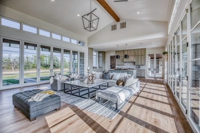 The home’s seamless flow reveals itself—an open expanse that connects cooking, dining, and gathering spaces in perfect harmony. Vaulted ceilings and abundant windows draw in the natural light, creating an atmosphere that feels both spacious and serene.