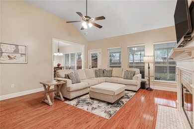 Bright living room features wall of windows and 12