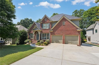 Traditional-style home with brick siding, driveway, and a front lawn