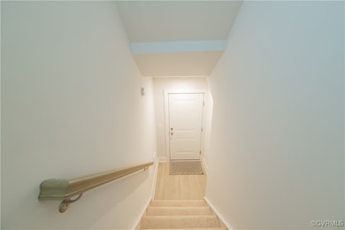 Staircase with baseboards and wood finished floors
